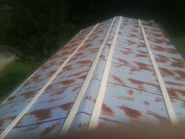 Rusted metal roof panels with new wood purlins before replacement — Storm Damage Roof Repair in Senoia by Roofing Brothers